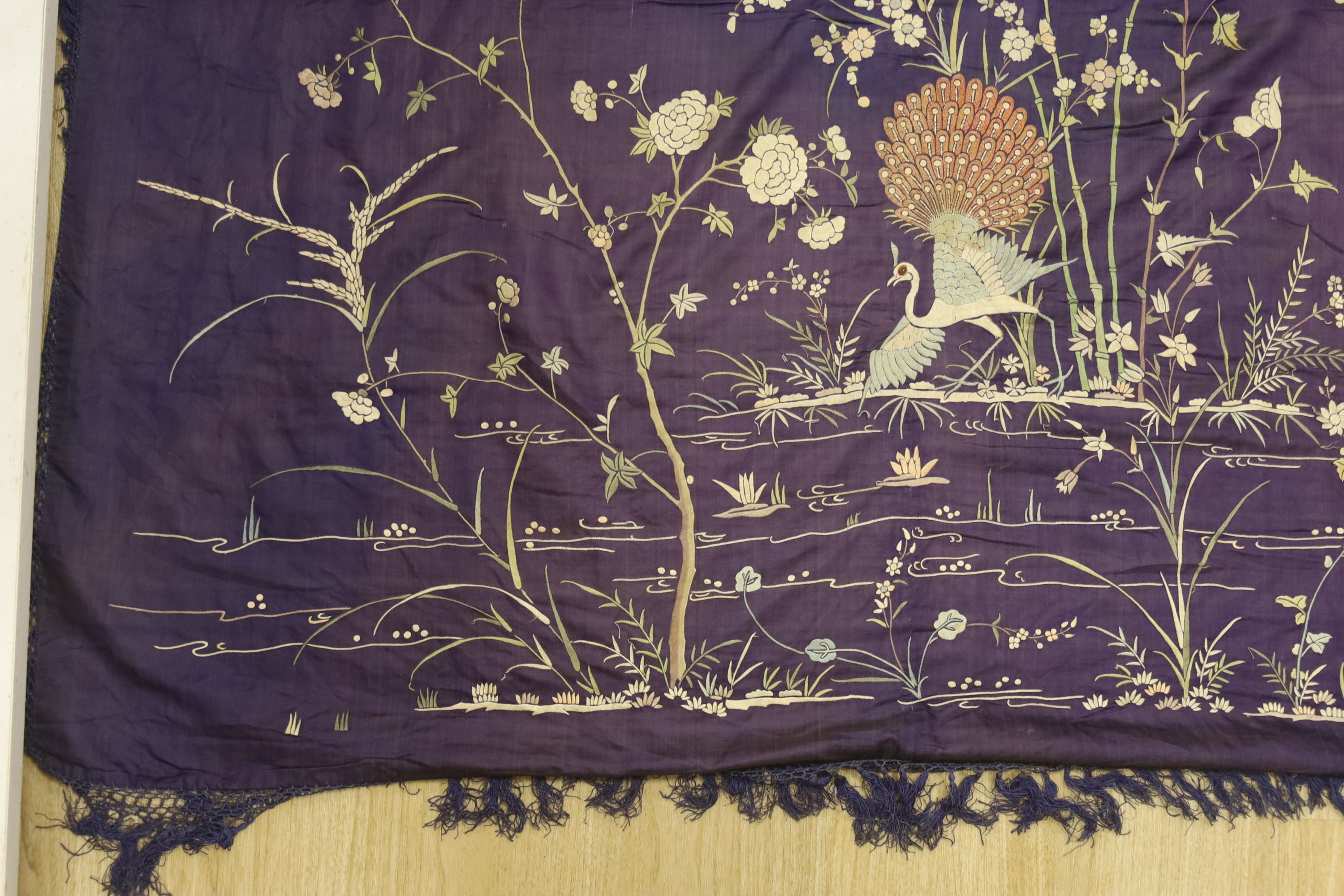 An early 20th century Chinese purple silk embroidered throw edged with trimming, 130 x 134cm